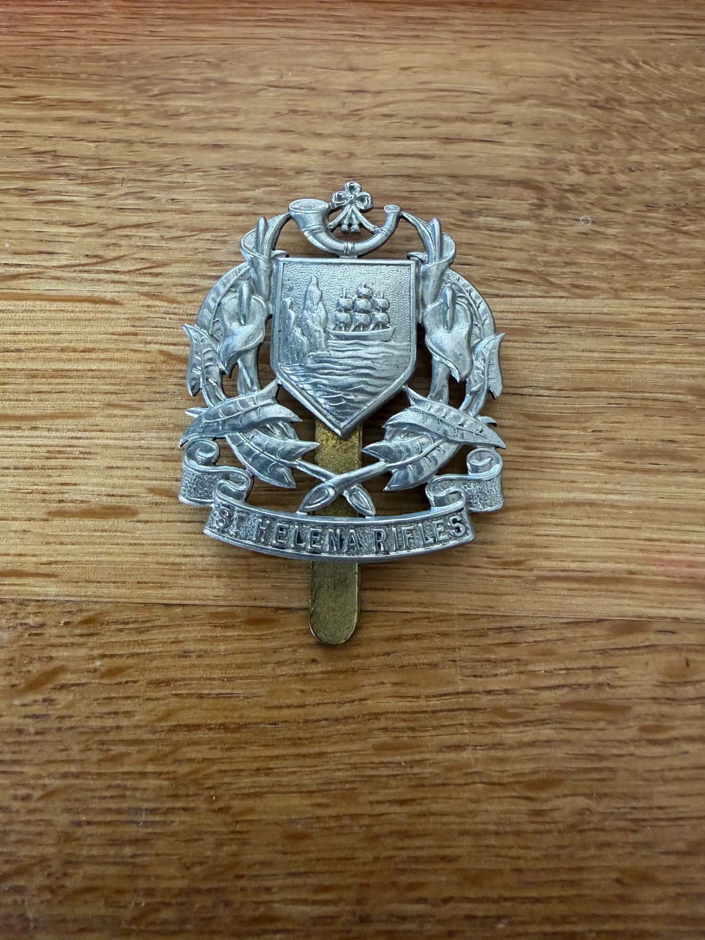 St Helena Rifles white metal cap badge, reverse showing slider fitting