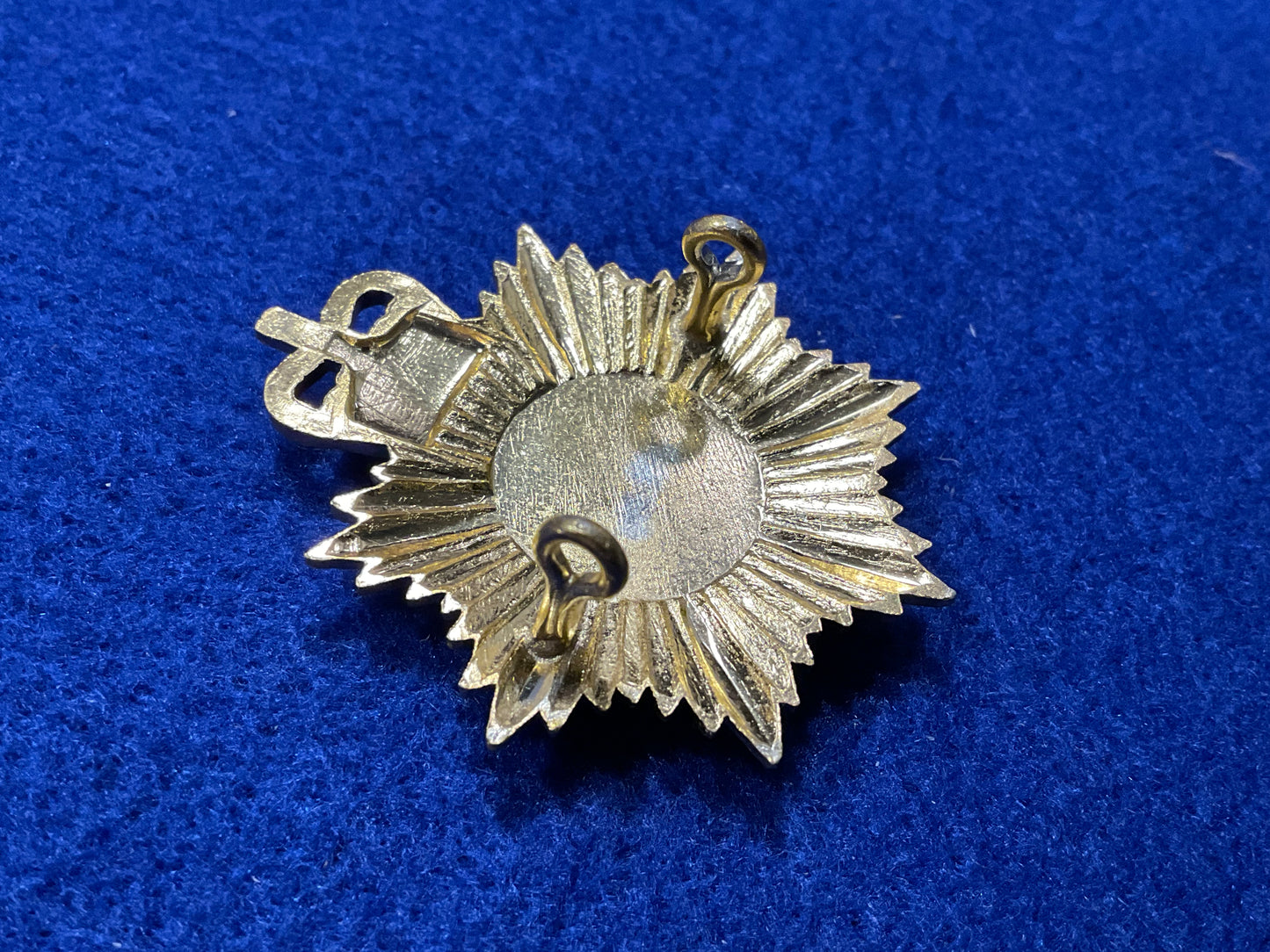 Anodised Royal Alderney Militia cap badge front