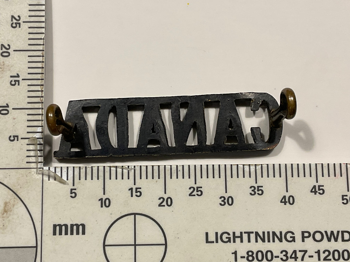 WW1 CEF small blackened brass ‘CANADA’ shoulder title