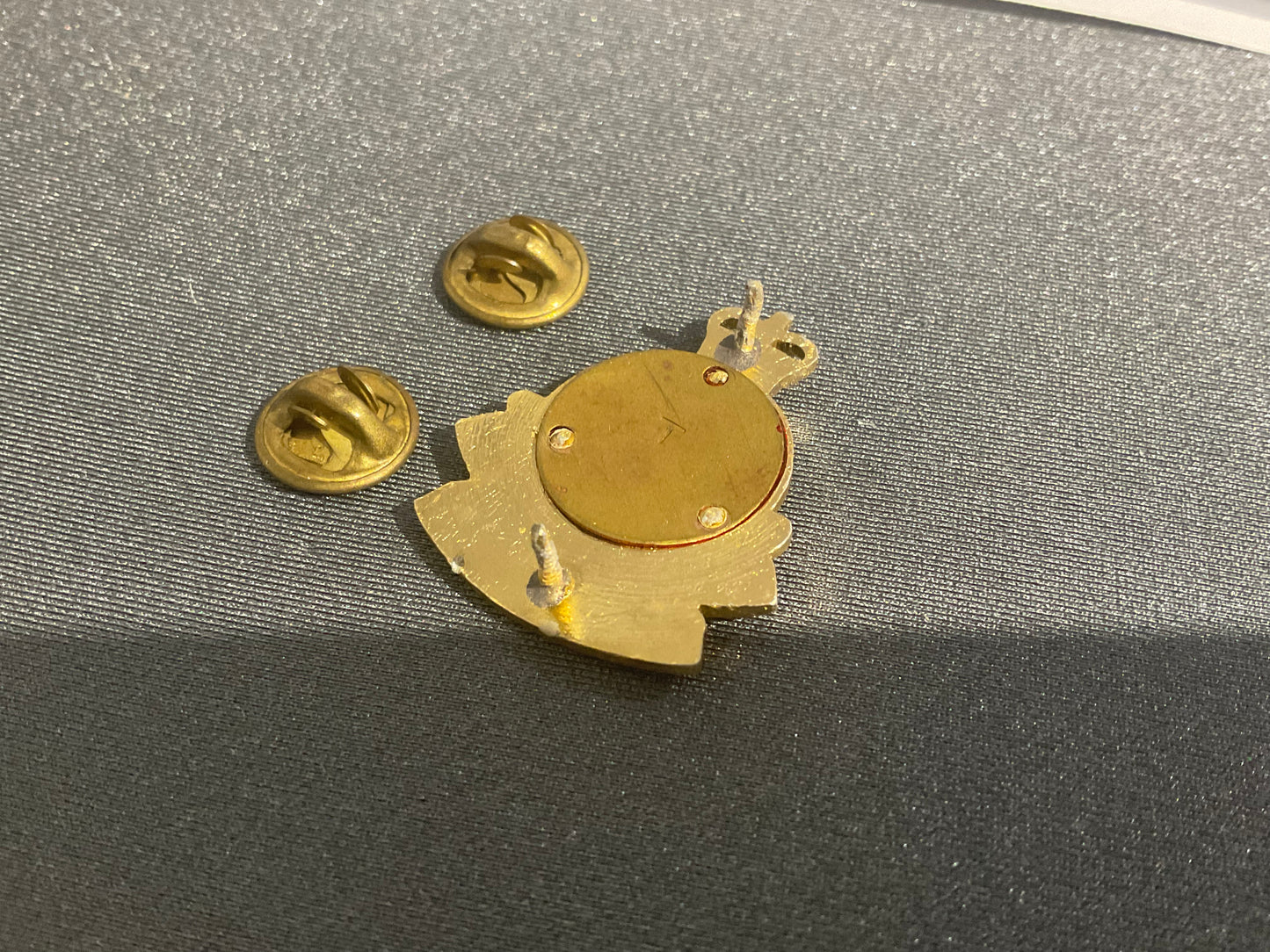 Anodised NZ Ordnance corps collar badge.