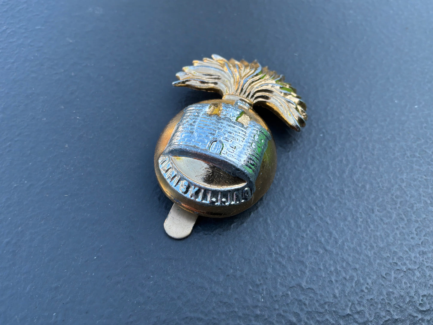 Anodised The Royal Inniskilling Fusiliers cap badge by Firmin.