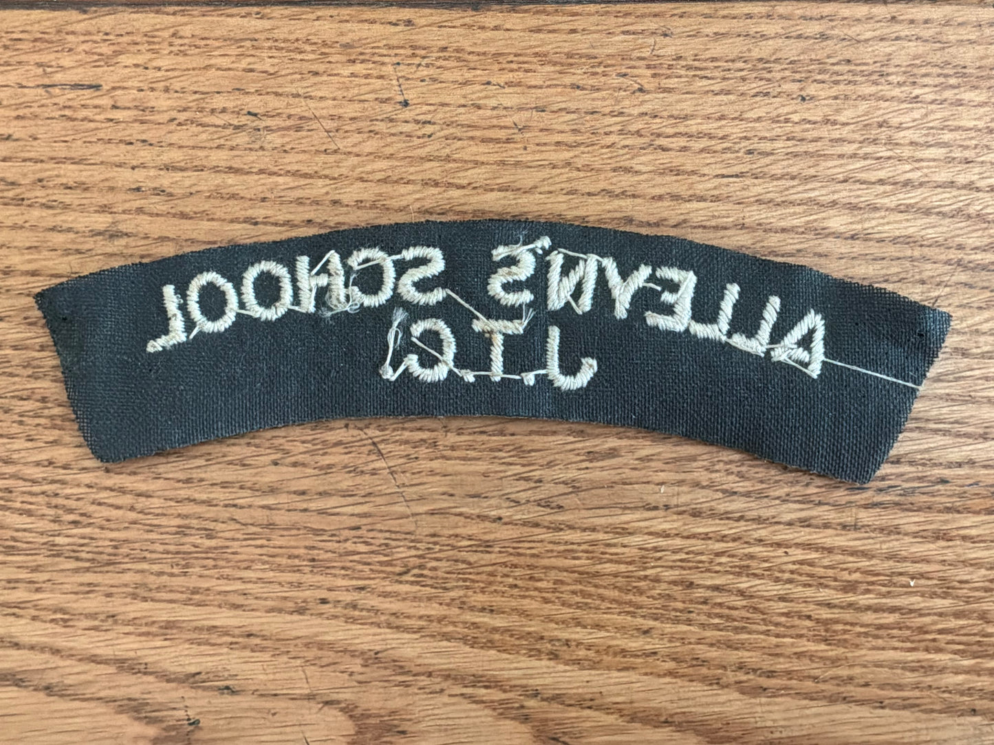 ALLEYN’S SCHOOL J.T.C white embroidery on black wool backing cloth shoulder title.