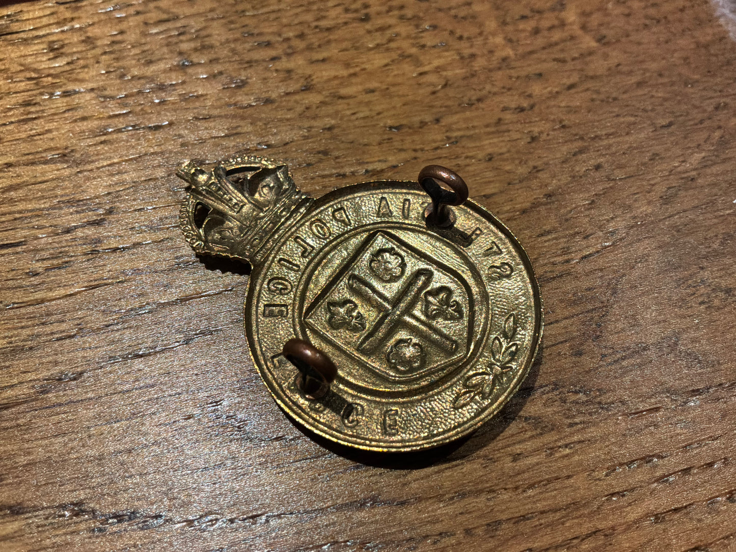 Pre 1952 K/C St Lucia Police brass cap badge.
