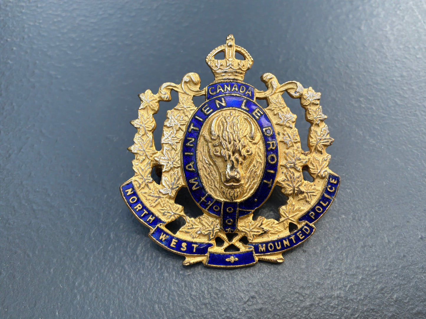1973 issue N.W.M.P gilt & enamel commemorative cap badge