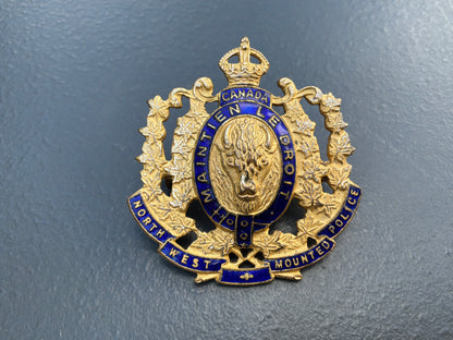 1973 issue N.W.M.P gilt & enamel commemorative cap badge