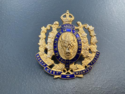 1973 issue N.W.M.P gilt & enamel commemorative cap badge