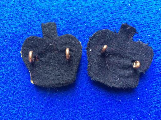 Post 1952 brass Queens Crowns with black backing