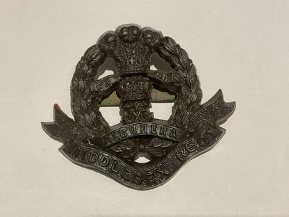 Gradia Militaria -  WW2 Middlesex Regiment plastic economy cap badge