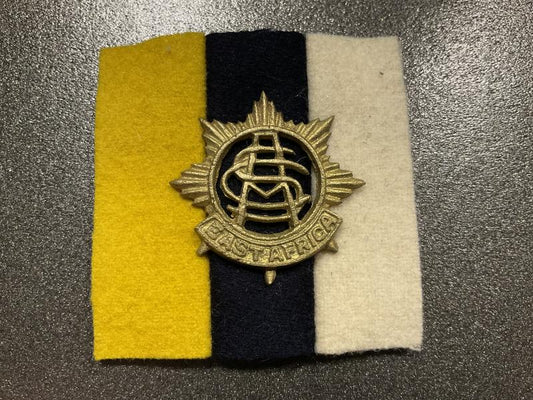 Gradia Militaria -  East Africa Army Service corps cap badge and backing