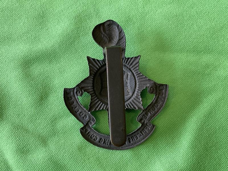 Eastbourne College O.T.C dark bronze finished cap badge