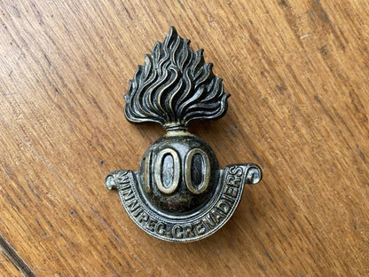 Gradia Militaria -  WW1 C.E.F 100th Winnipeg Grenadiers cap badge
