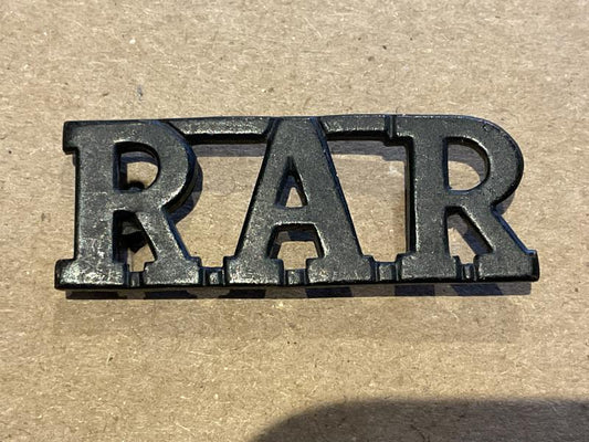 Gradia Militaria -  Rhodesian African Rifles (R.A.R) blackened brass title.