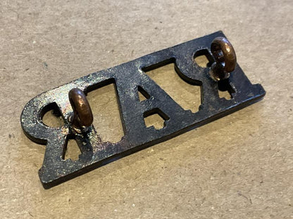 Rhodesian African Rifles (R.A.R) blackened brass title.