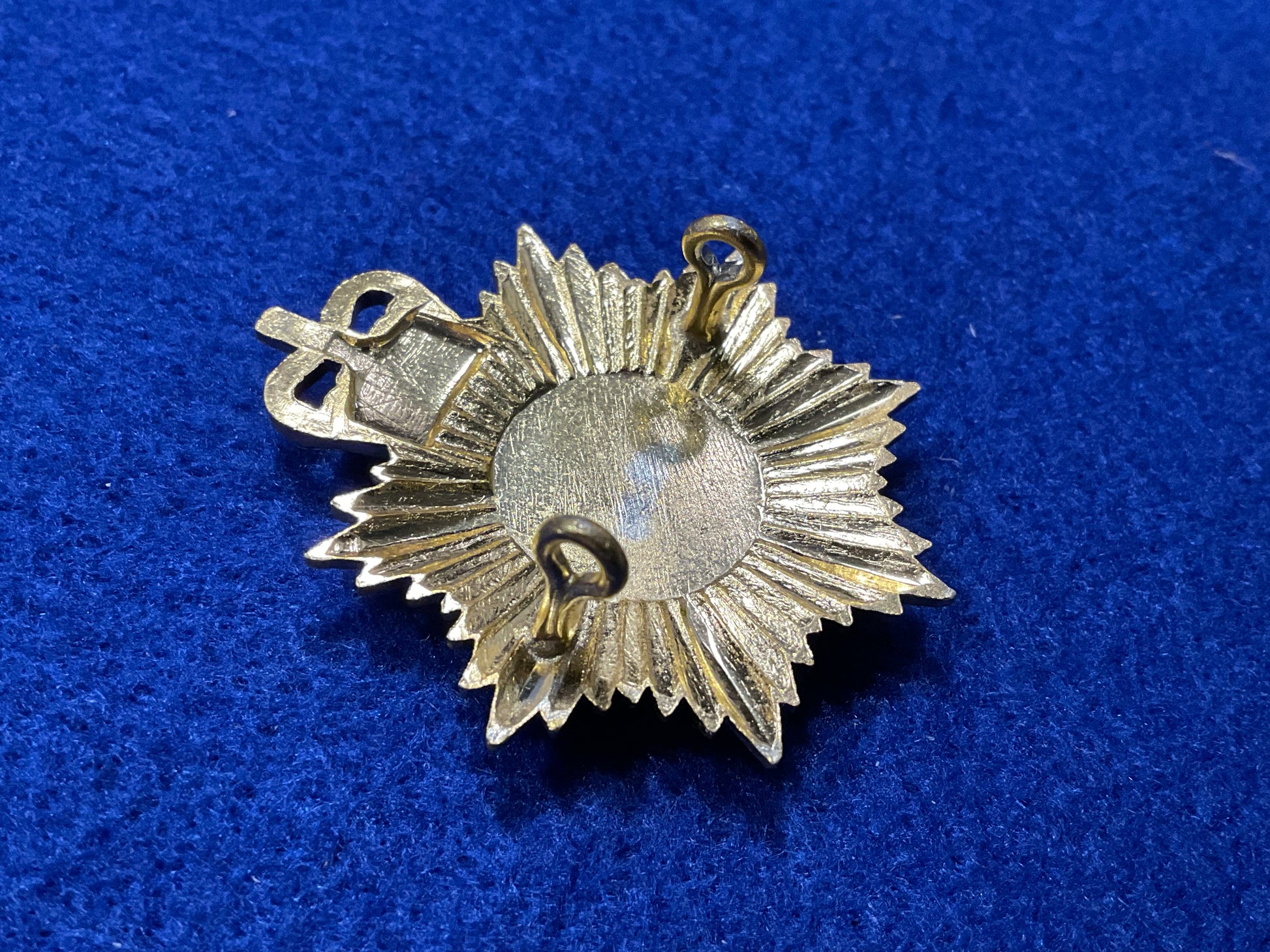 Anodised Royal Alderney Militia cap badge front