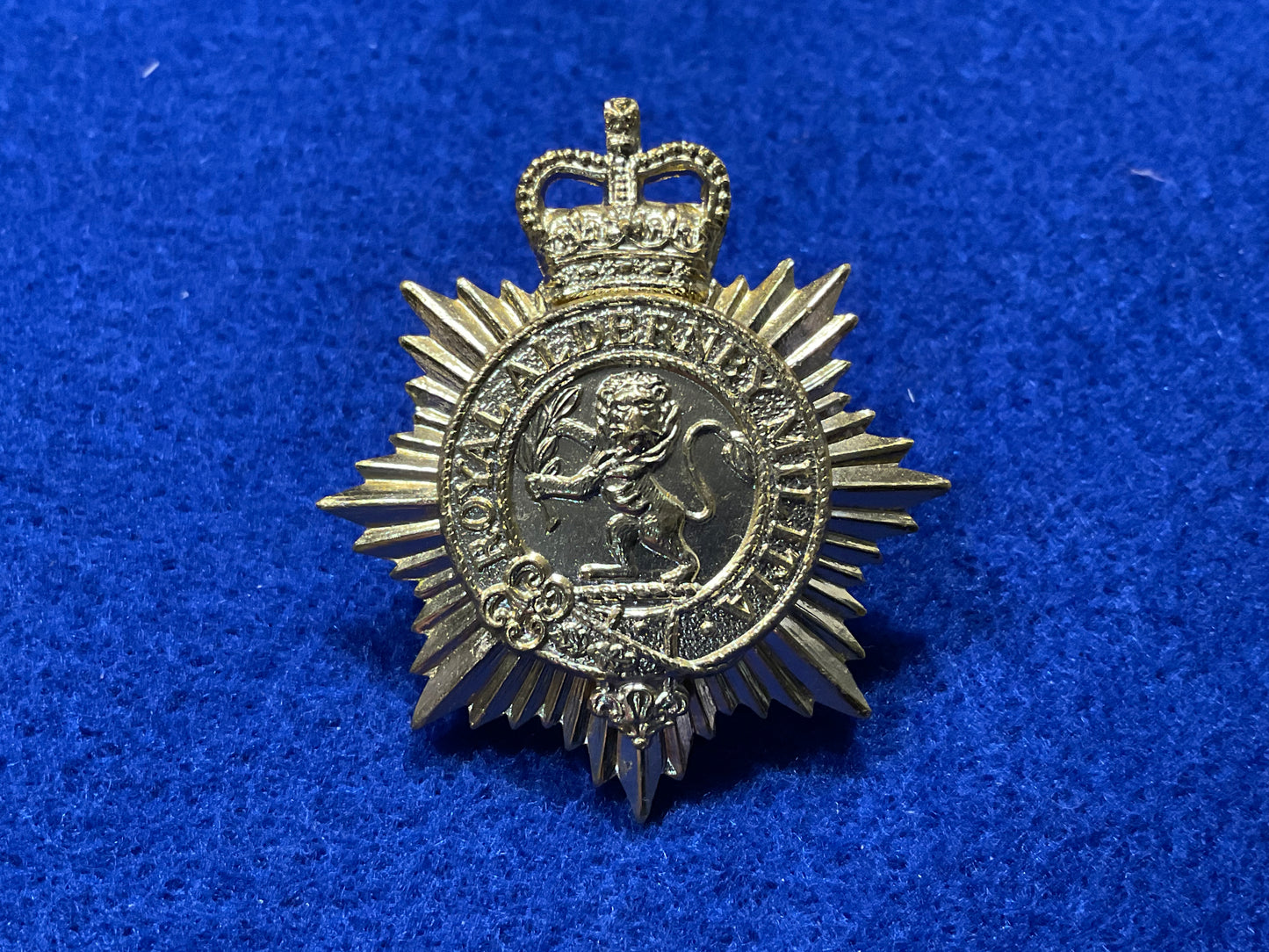 Anodised Royal Alderney Militia cap badge front