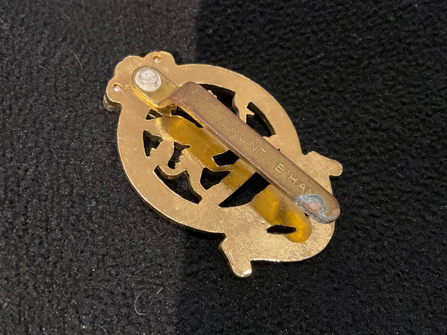 The Queens Regiment, early anodised cap badge with riveted brass slider