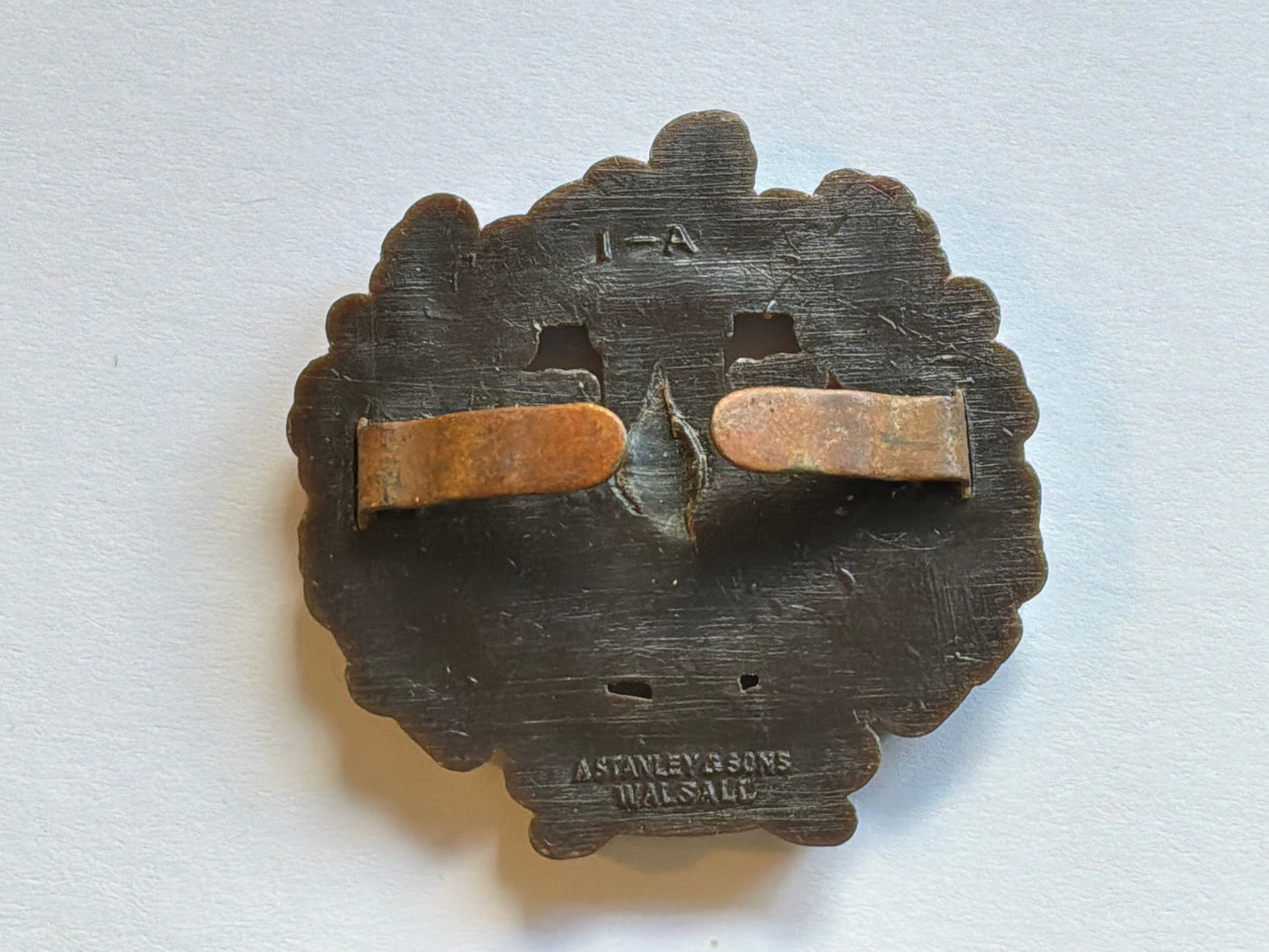 WW2 Essex Regiment plastic economy cap badge.