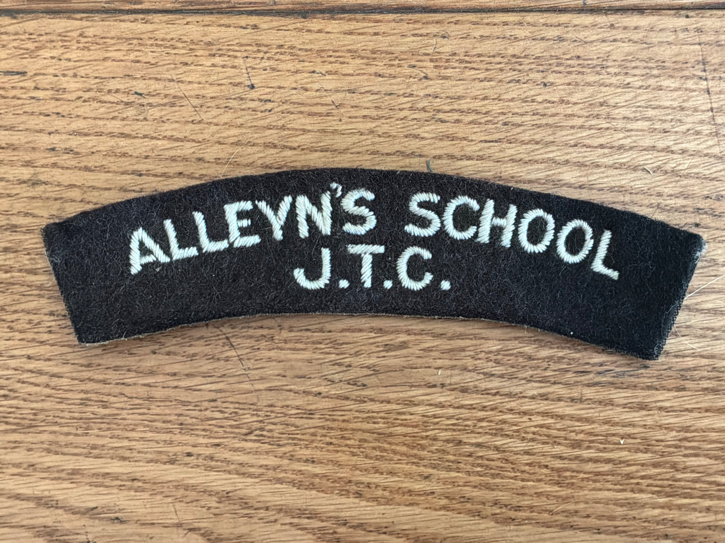 ALLEYN’S SCHOOL J.T.C white embroidery on black wool backing cloth shoulder title.