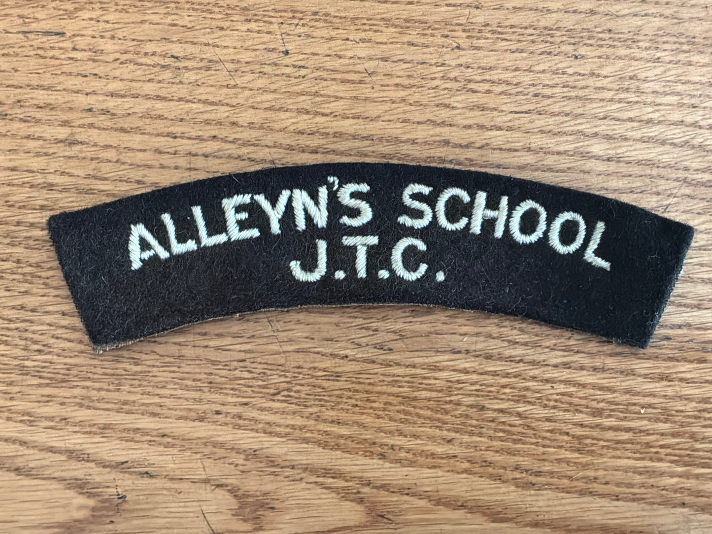 ALLEYN’S SCHOOL J.T.C white embroidery on black wool backing cloth shoulder title.