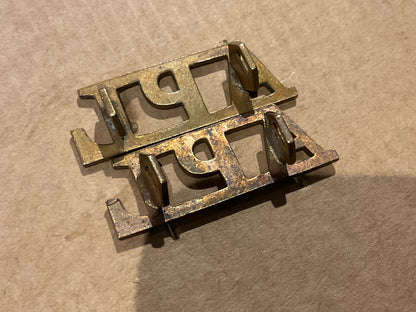 APL (Aden Protectorate Levies) brass shoulder titles