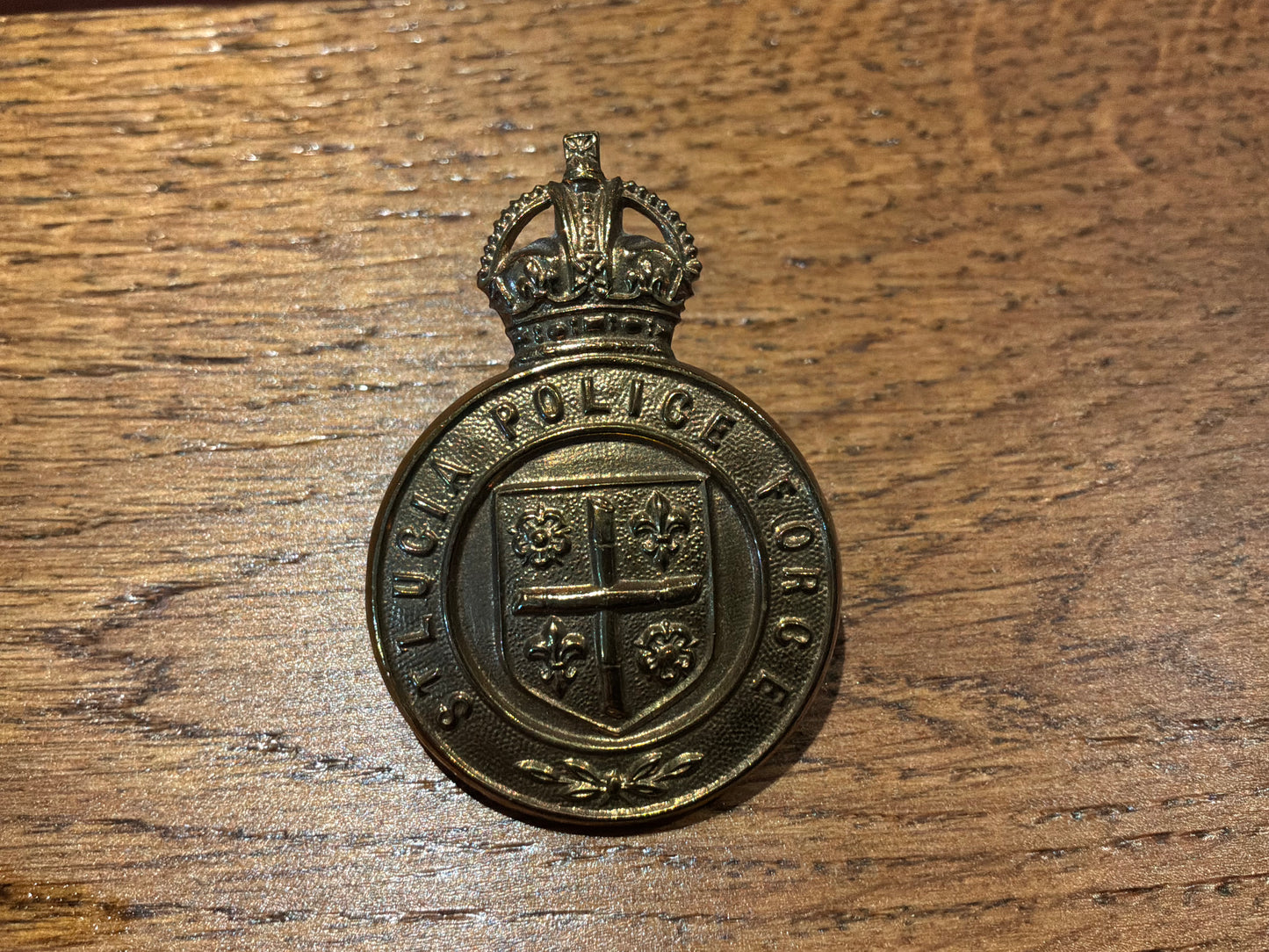 Pre 1952 K/C St Lucia Police brass cap badge.
