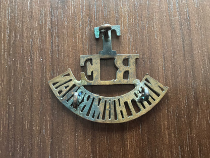 T/RE/NORTHUMBRIAN brass shoulder title.
