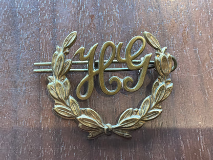 British Army Hotchkiss Gunner (“HG”) proficiency 2 part brass arm badge.