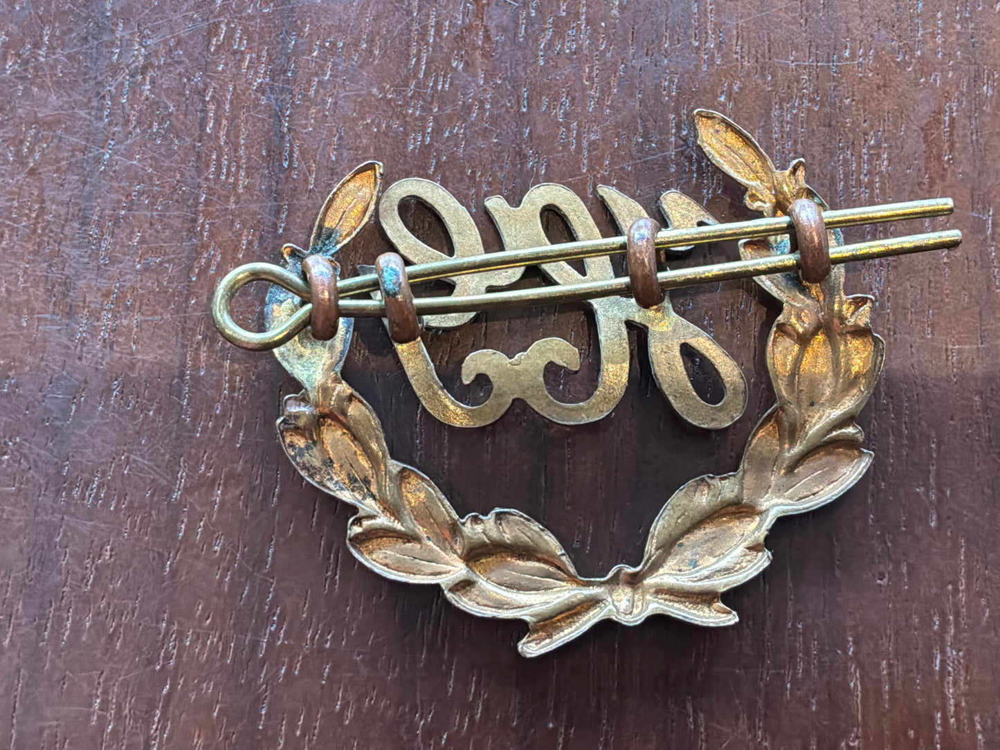 British Army Hotchkiss Gunner (“HG”) proficiency 2 part brass arm badge.