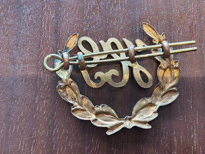British Army Hotchkiss Gunner (“HG”) proficiency 2 part brass arm badge.