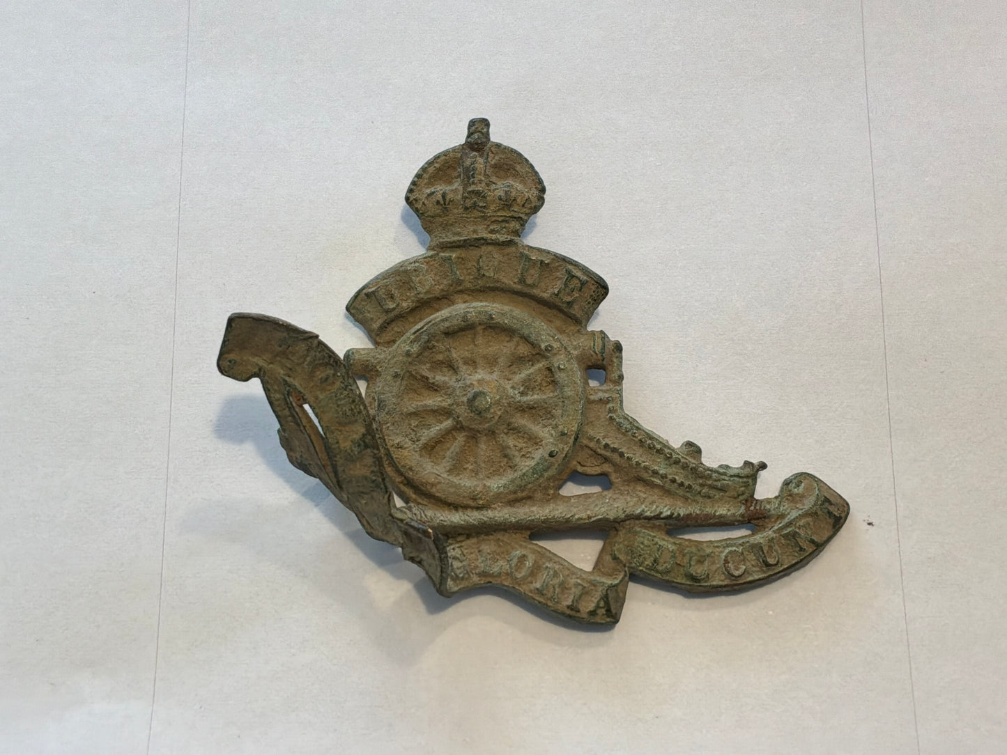 WW1 Economy brass R.A cap badge in relic condition from the Somme area.