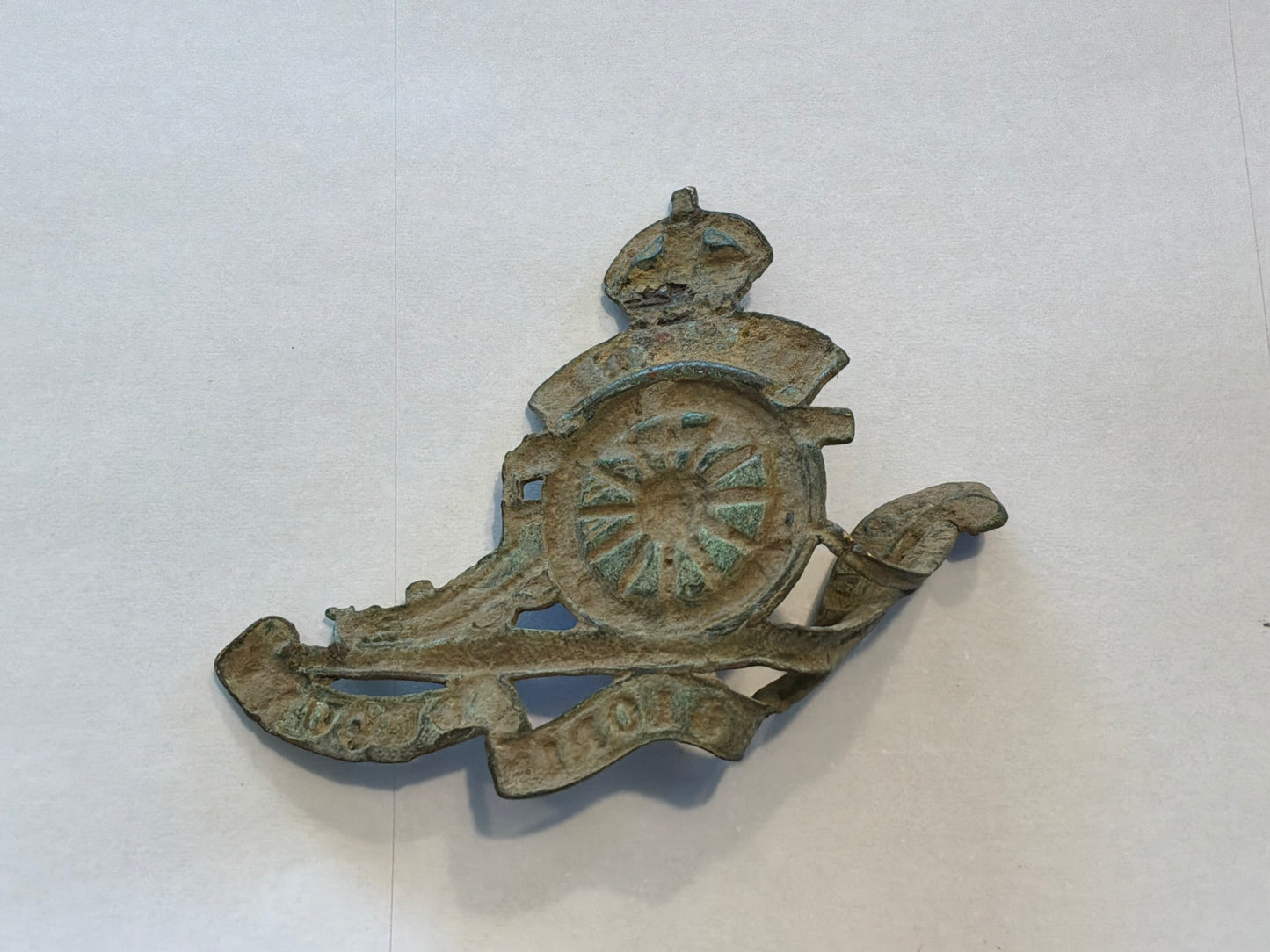 WW1 Economy brass R.A cap badge in relic condition from the Somme area.