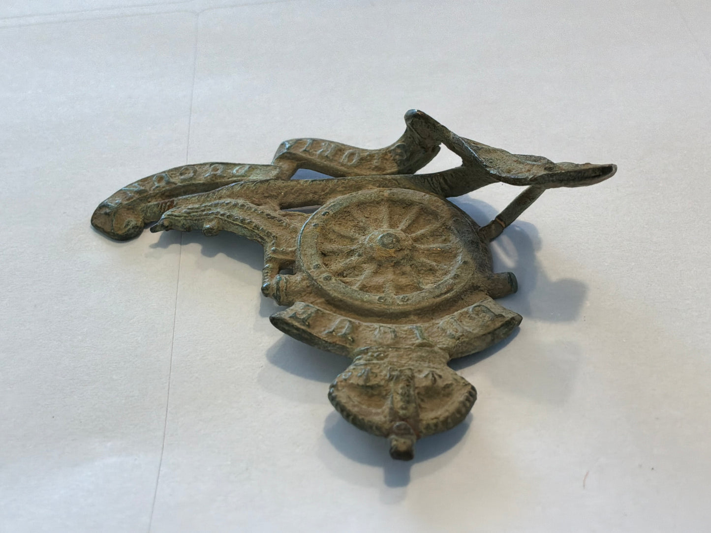 WW1 Economy brass R.A cap badge in relic condition from the Somme area.