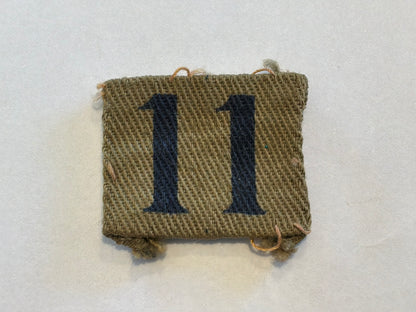 WW2 Printed number ‘11’ Home Guard designation badge.