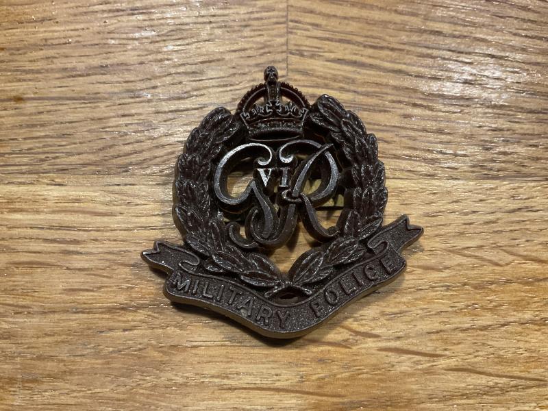 WW2 Plastic economy issue Military Police cap badge.